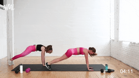 two women performing a plank jack and pike tuck on a cardio and ab workout