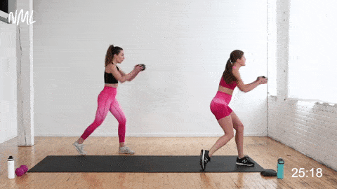 two women performing a shuffle pivot pass in a HIIT cardio abs workout