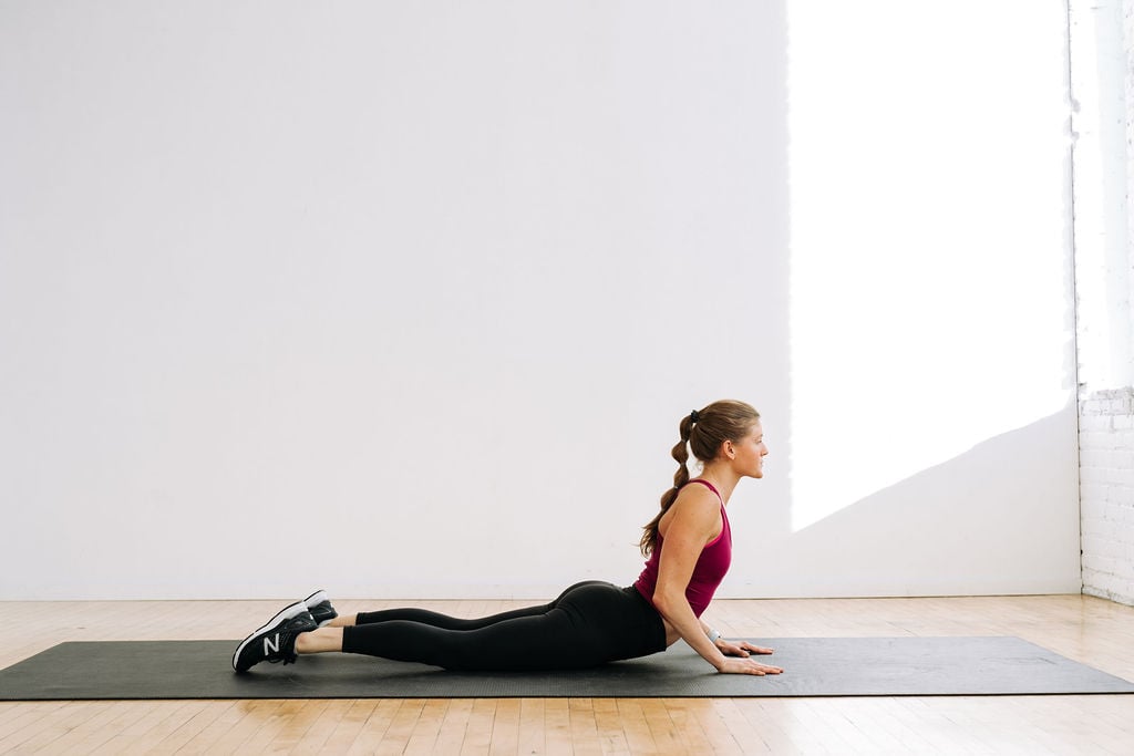 woman performing a yoga back stretch in active recovery flow yoga