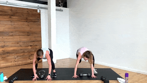 two women performing a burpee with overhead kettlebell press in a full body kettlebell workout