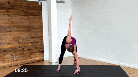 woman performing a forward fold and spinal rotation