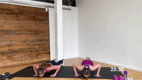 how to do push ups (one woman performing standard push ups from toes and another performing modified push ups from knees)