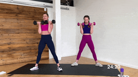 two women performing a sumo squat and bicep curl as a full body exercise at home