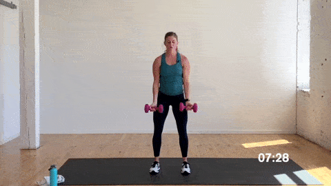 woman performing a bicep curl and overhead shoulder press in a superset workout