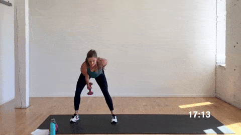 woman performing a dumbbell swing with lateral hop in a superset workout