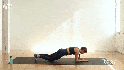 woman performing a rolling plank in a beginner ab workout for a strong core
