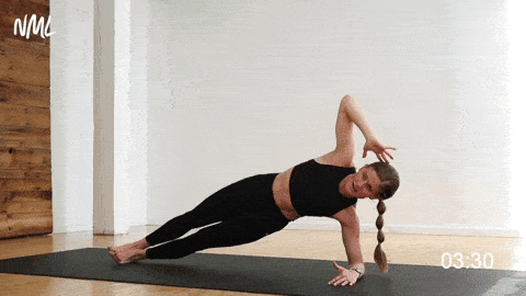woman performing a side plank crunch in an ab workout