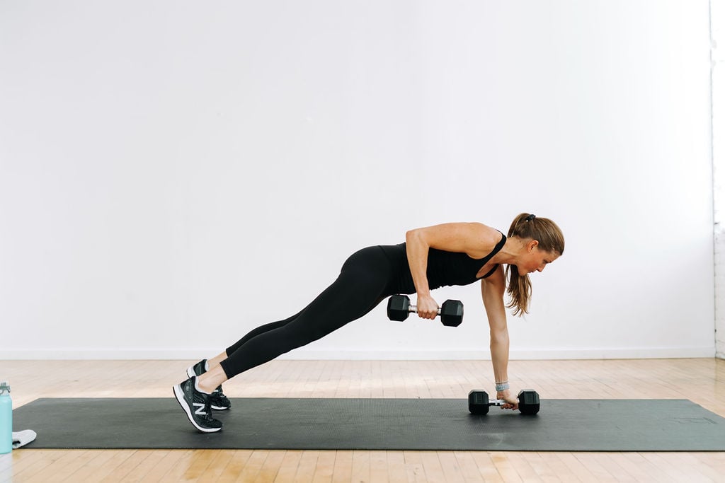 woman performing a single arm dumbbell row in a Back and Biceps Workout