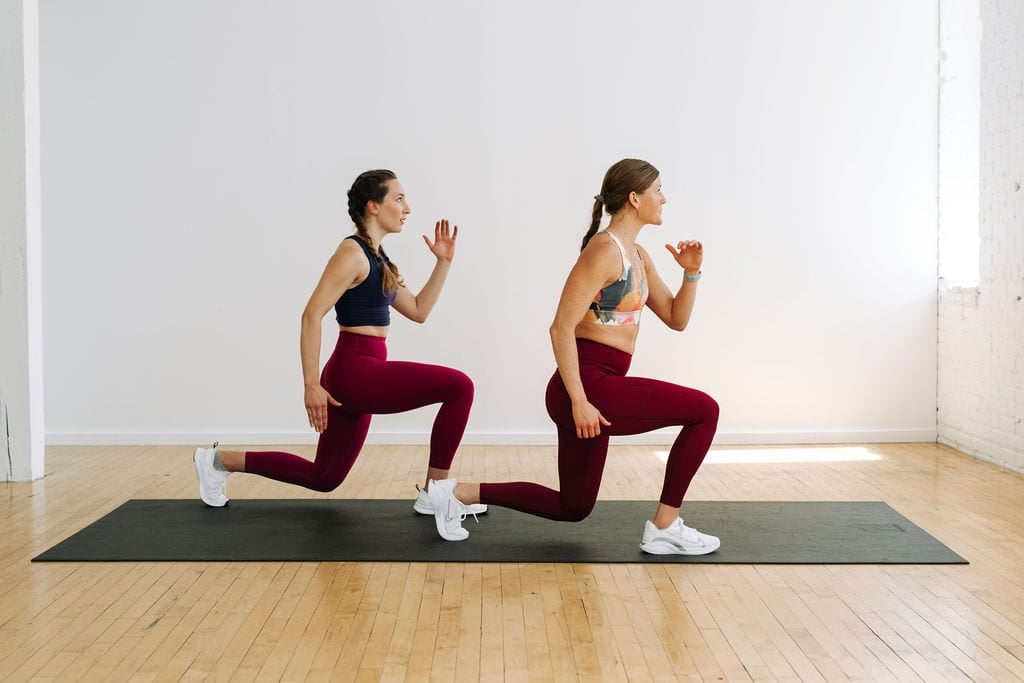 two women performing lunge jumps in a no equipment full body tabata workout