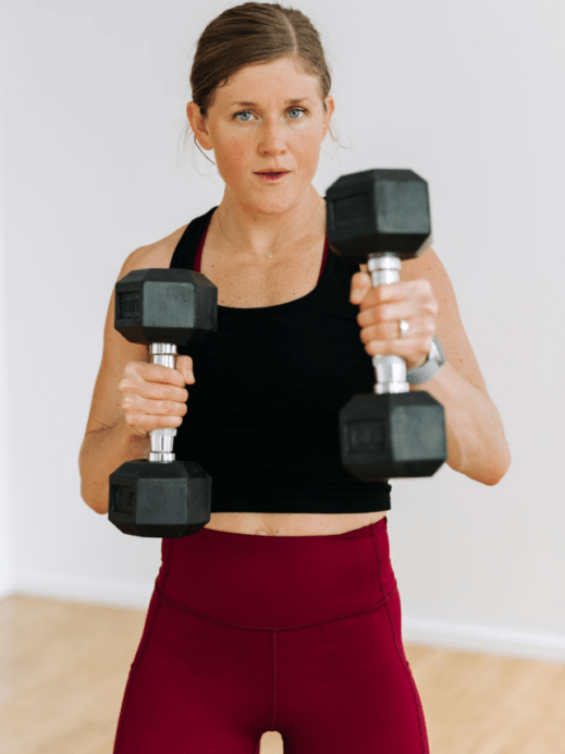 Women doing a dumbbell punch as a strength training for runners exercise.