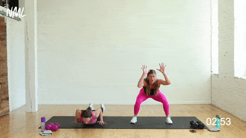 two women performing hand release high tens or half burpees in a strength and conditioning workout