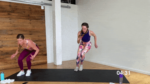 two women performing lateral squat jumps as part of a no equipment Tabata workout at home