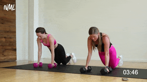 two women performing push ups in a strength and conditioning workout