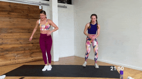 one woman performing squat jacks and one woman performing low impact squat heel taps as part of a bodyweight tabata workout at home