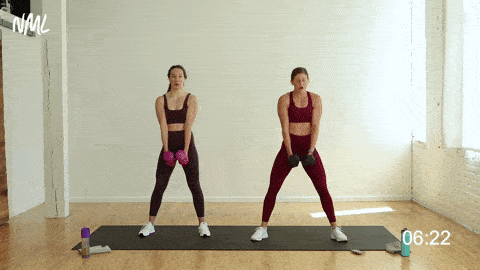 two women performing two wide squats and one push up as a compound exercise in a home workout