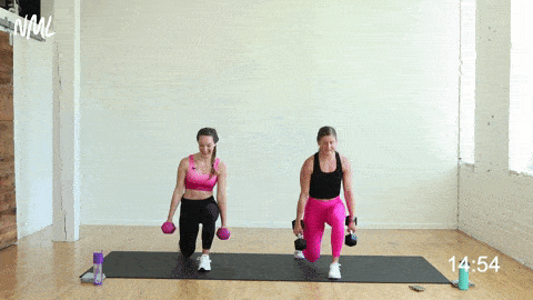 two women performing a weighted single leg plyo lunge in a strength and conditioning workout