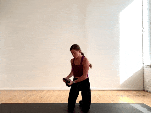 woman performing a kettlebell halo as a kettlebell ab exercise