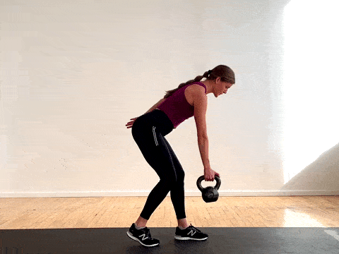 woman performing a single arm back row with a kettlebell as part of the best kettlebell exercises for women