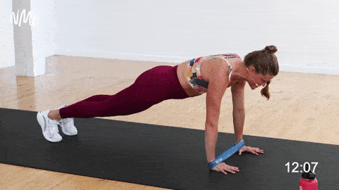 woman performing banded push ups in a resistance band arm workout 