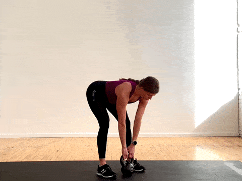 woman performing a deadlift clean squat with a kettlebell in a workout for women
