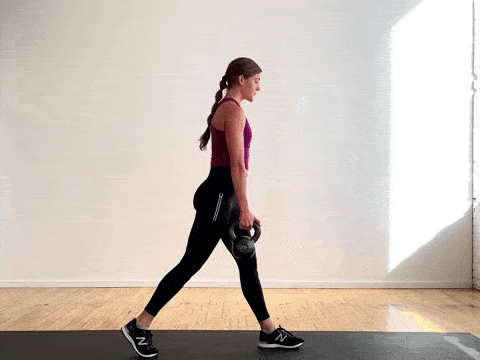 woman performing an uneven split lunge with a kettlebell in a total body HIIT workout