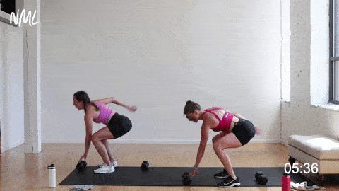 two women performing 180 squat jumps in a full body HIIT workout