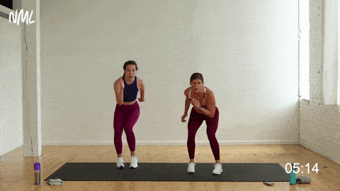 two women performing a loaded squat and lateral push back 45 degrees in a cardio workout at home