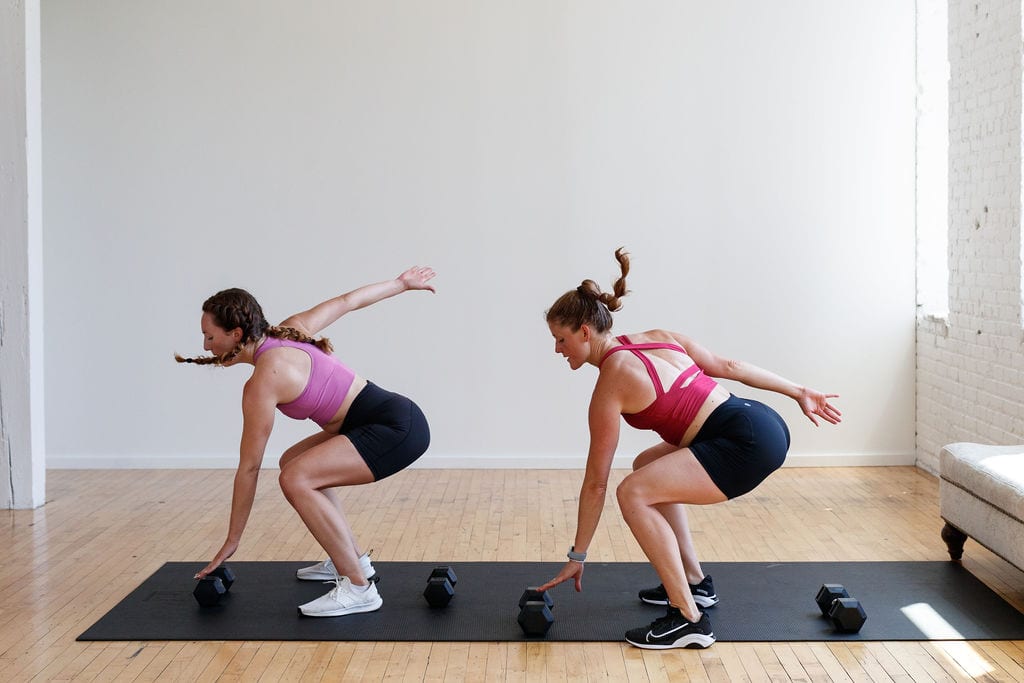 two women performing 180 squat jumps as part of athletic drills at home in a high intensity workout at home