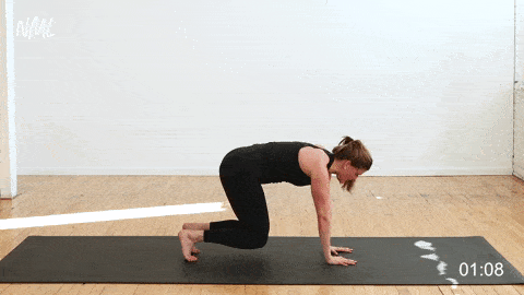 woman performing bear crawl toe taps for the lower abs