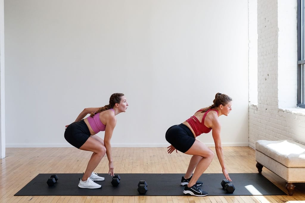 two women holding a low squat in a HIIT workout