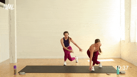 two women performing a curtsy lunge into a lateral lunge in a cardio workout at home