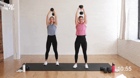 two women, one pregnant, performing an overhead tricep extensions as part of first trimester exercises at home