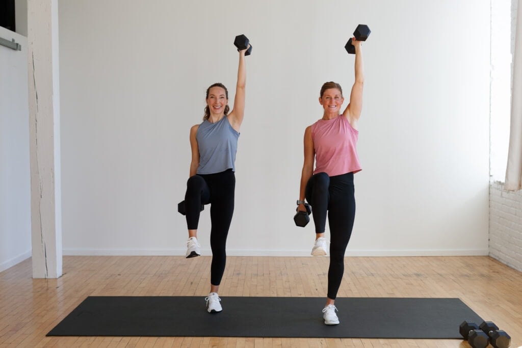 two women performing a balance overhead press with a dumbbell as part of first trimester exercises