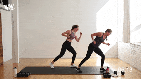 two women performing a knee drive and beat down punch in a cardio workout at home