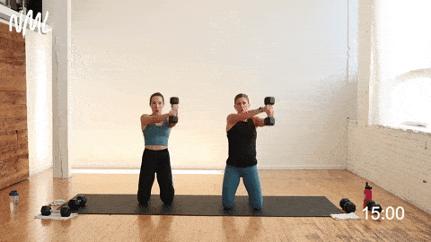 two women performing a dumbbell press out and figure 8 for shoulders in an upper body workout at home