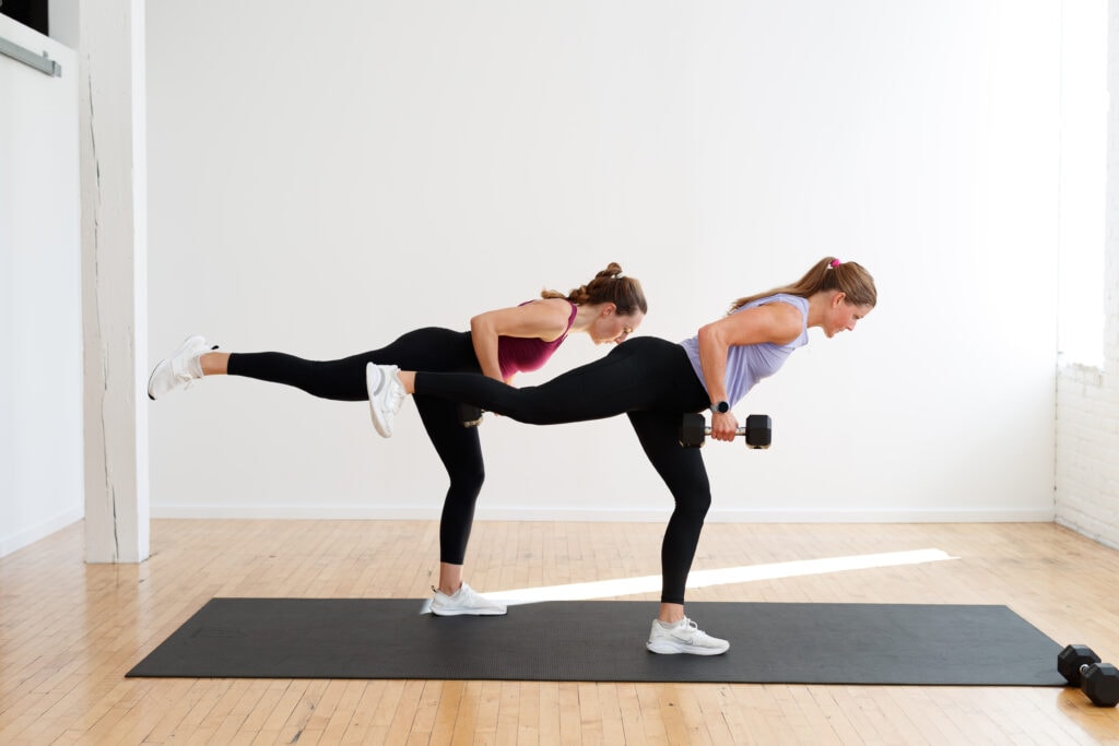 two women performing a single leg deadlift and single arm back row in a first trimester hiit workout