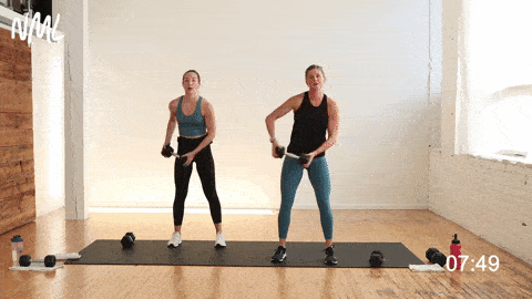 two women performing a halo abs or dumbbell halo core exercise
