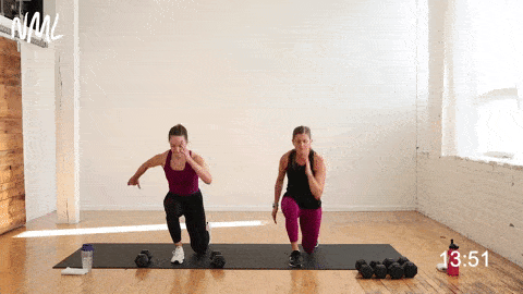 two women performing lunge drops in a leg superset workout
