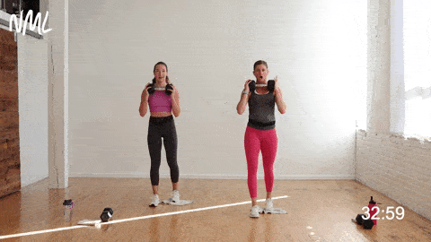 two women performing a narrow lunge and towel slide in a unilateral workout