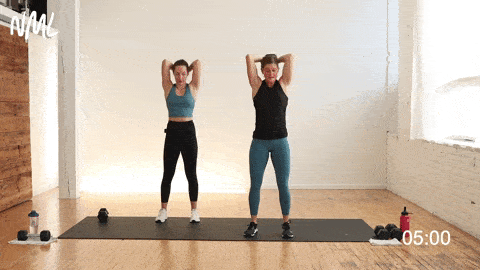 two women performing overhead tricep extensions with one dumbbell