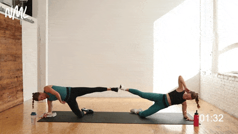 two women performing a side plank kick out in a bodyweight workout at home