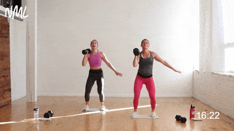 two women performing a single sided push press and low impact burpee