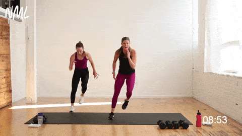 two women performing single sided skaters in a leg superset workout