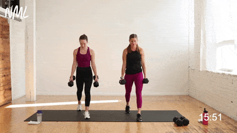 two women performing a split lunge in a leg superset workout