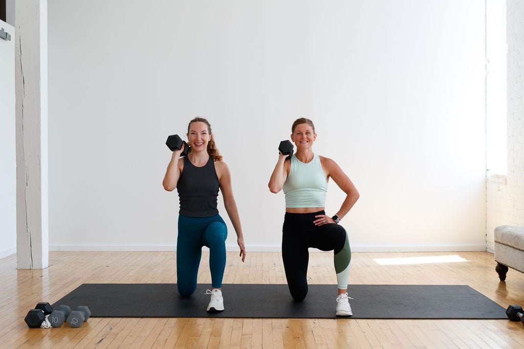 two women performing kneeling shoulder raise