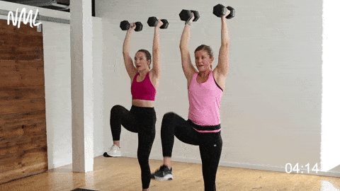 two women performing an overhead march in a back and arm workout