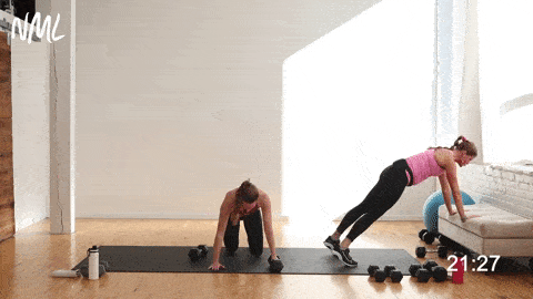two women performing two push ups and two single arm rows in an arms and back workout for women
