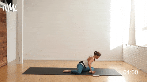 woman performing a 90/90 hip stretch to release tight hips