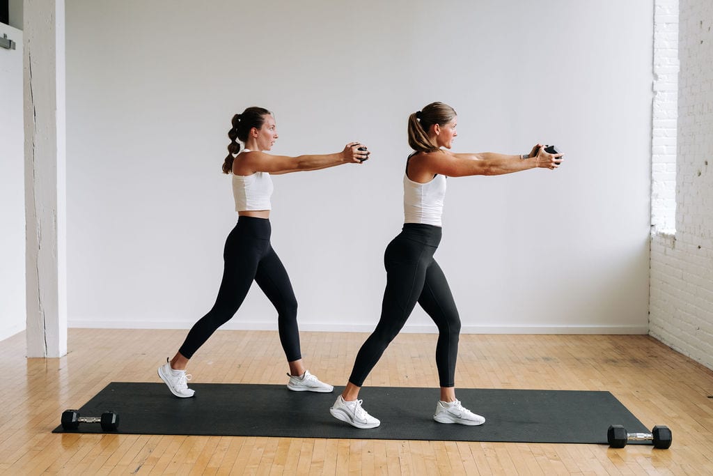 Two women performing dumbbell press out as part of full body hiit workout