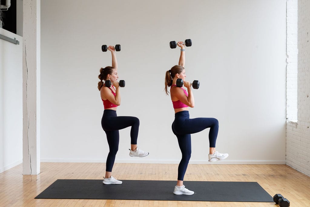 two women performing an overhead press | hiit abs workout